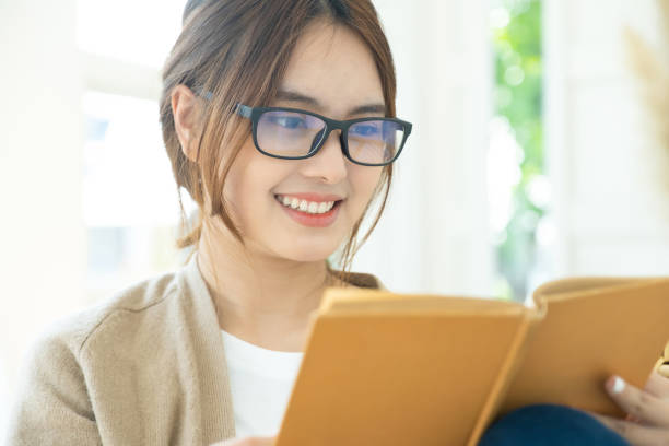 istock Young collage student reading a book sitting in a chair. 1405539151
