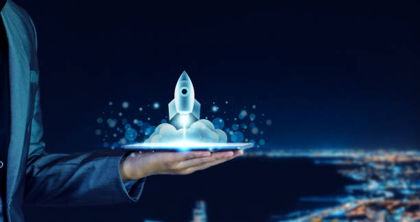 istock Startup business concept. Businessman holding a tablet, rocket launching and soar flying out from screen, starting a business, growing business, modern technology, hologram, network connection. 1405540149