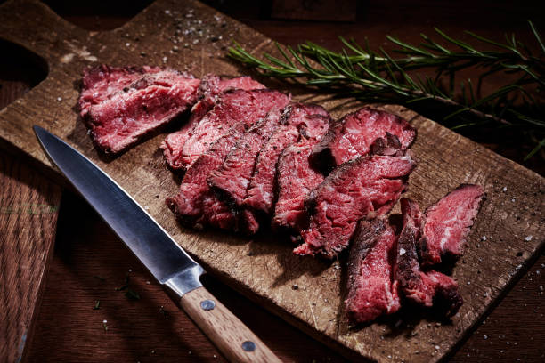 istock Delicious fillet steak slices with condiments on cutting board 1405540476
