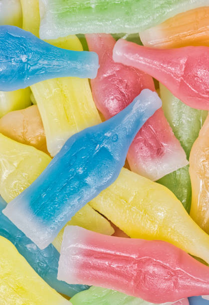 istock Wax Bottles candy scattered with assorted colors and flavors. 1405541333