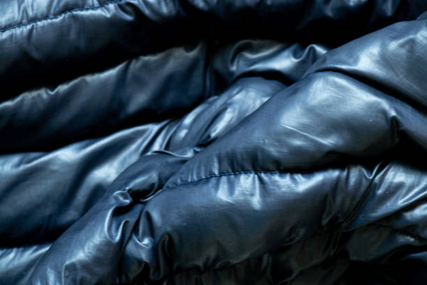 istock black puffed men's winter jacket as background, down jacket close up 1405541380
