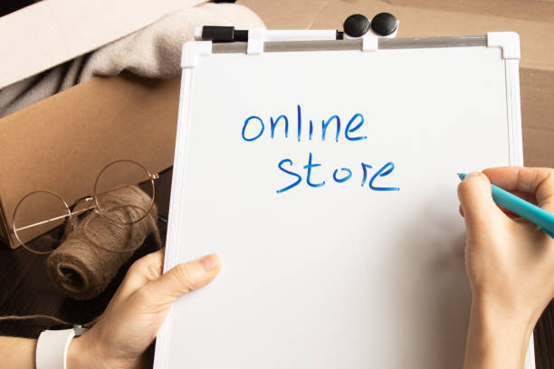 istock online store, small business owner, entrepreneur, mailbox prepares a parcel on the table for shipment. Dropshipping delivery concept in e-commerce, on tablets on written online store 1405542343