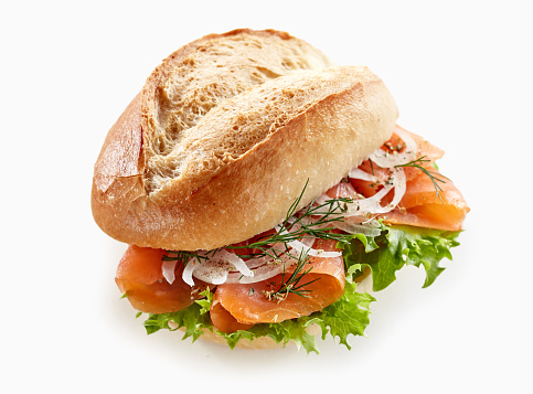 From above of tasty sandwich with salmon and onion placed on white isolated background in studio