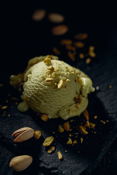 istock Delicious pistachio gelato scoop on dark surface 1405543453