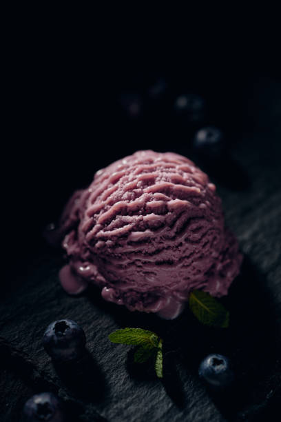 istock Delicious blueberry ice cream ball on dark surface 1405543707