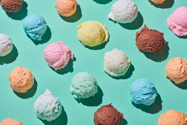 Colorful ice cream balls on table Top view of seamless background of assorted scoops of ice cream arranged in lines on blue table scoop shape stock pictures, royalty-free photos & images
