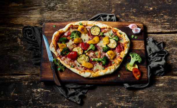 istock Delicious pizza with vegetables on wooden table 1405543843