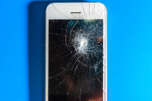 istock crashed smartphone with broken black screen on blue background. Top view. Repair concept. 1405545196