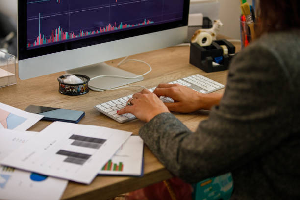istock Businesswoman typing data on computer keyboard while making a financial report for a project 1405546589