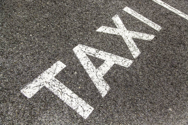 istock Taxi sign on the asphalt 1405548059