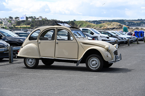 Erquy, France - June 26, 2022: An old being old timer classic Citroen 2CV (Dodoche ) car in a very good shape. The Citroën 2CV (French deux chevaux \