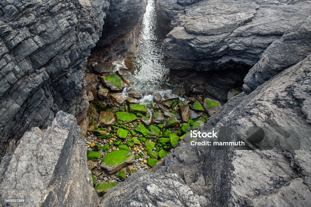 Heart shaped hole in the rocks Rock formation in Ireland Beauty In Nature Stock Photo