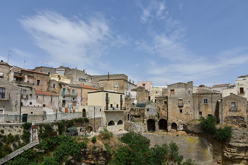 The roofs of the old houses of Sorano and, in background, the imposing bulk of the medieval Fortezza Orsini, seat of the Civic and Archaeological Museum