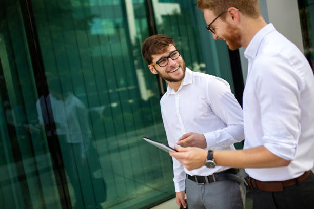 istock Two successful business men walking outdoors. Business, friendship, communication concept 1405558489