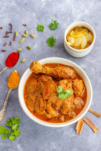 istock Flavourful Chicken Do Pyaza in a Bowl with Assorted Spices Top Down Vertical Photo 1405559665