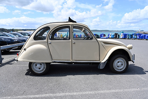 Erquy, France - June 26, 2022: An old being old timer classic Citroen 2CV (Dodoche ) car in a very good shape. The Citroën 2CV (French deux chevaux 