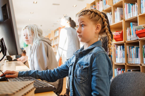 istock Two beautiful female sister students studying in a public library 1405561352