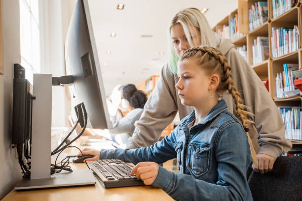 istock Two beautiful female sister students studying in a public library 1405561399