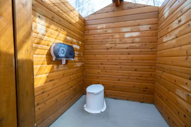 Photo of Wooden public lavatory in the Jasper National Park. Countryside toilet concept.