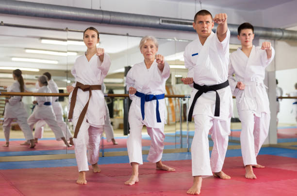 istock Various aged men and women training kata moves 1405561513