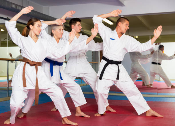 istock Various aged men and women training kata moves 1405561589