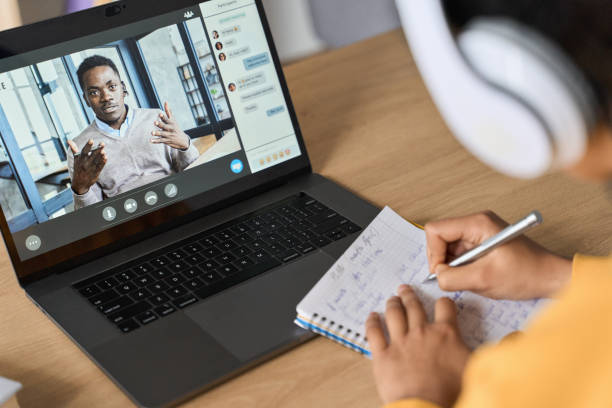 istock African American female student having video educational class on laptop. 1405564230