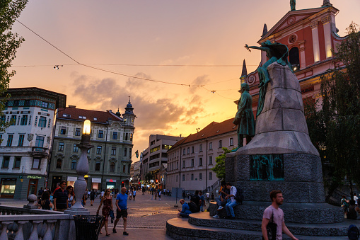 Preseren Square with monument in Ljubljana historical full of tourists at dusk in summertime