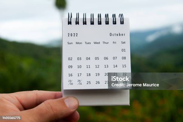 Hand Holding October 2022 Calendar With Copy Space And Nature Background Stock Photo - Download Image Now