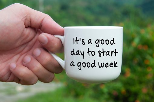 It is a good day to start a good week text on coffee cup. New day concept