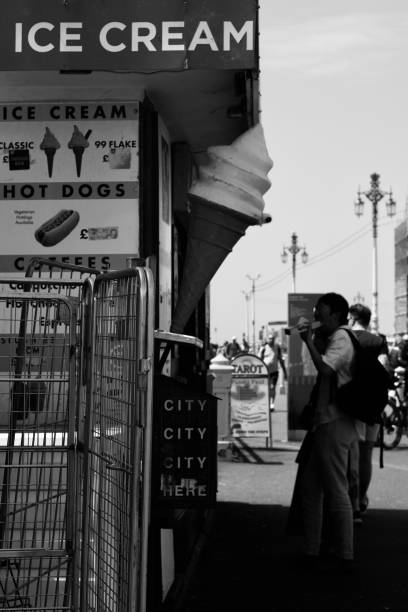 Vendors by Brighton Palace Pier. Captured on the 28th June 2022. Brighton is a seaside resort and one of the two main areas of the City of Brighton and Hove. Located on the south coast of England, in the county of East Sussex, it is 47 miles south of London. Archaeological evidence of settlement in the area dates back to the Bronze Age, Roman and Anglo-Saxon periods