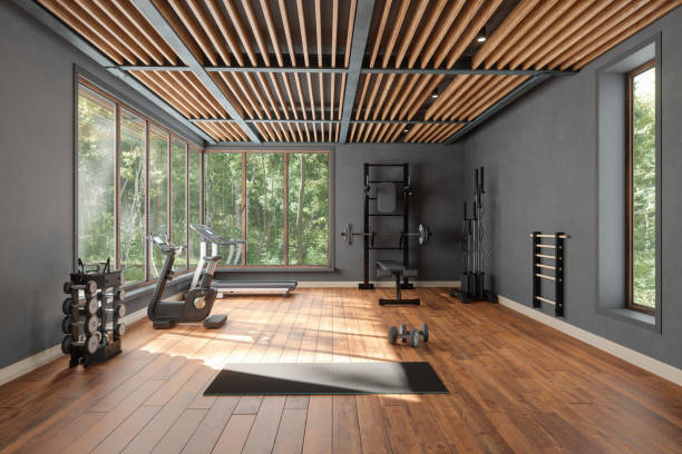 personal training studio with barbell, dumbbells, exercise bike and garden view from the window - gym imagens e fotografias de stock