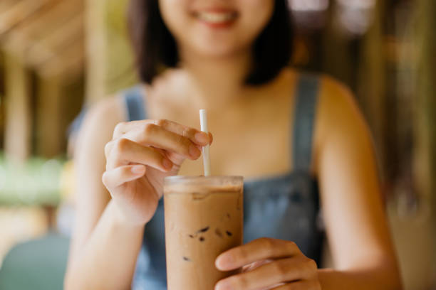 istock Woman drinking with a paper straw 1405572752