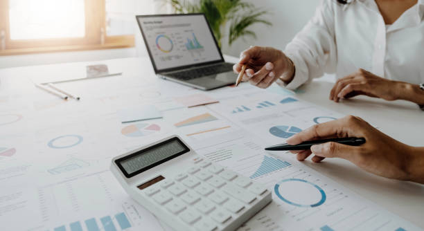 istock Business team analyzing income charts and graphs with modern laptop computer. Close up.Business analysis and strategy concept. 1405573007