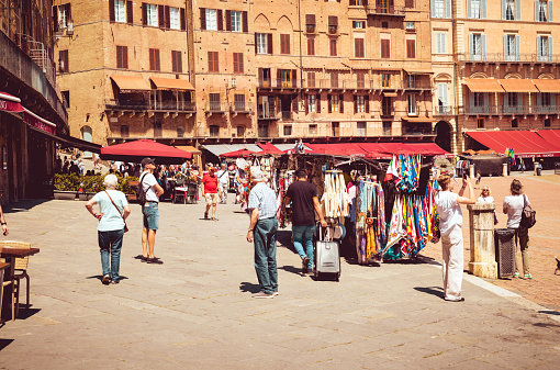 Locals and tourists at the Piazza del Campo in the renaissance town of Siena, in the Tuscany region of Italy.