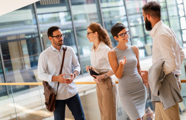 istock Business people having fun, teamwork and chatting at workplace office together. 1405574224