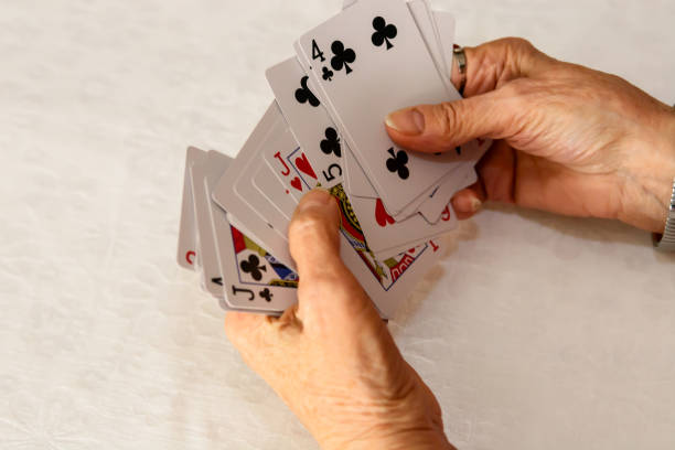 Macro shot of an old Jack of clubs playing card (knave) isolated on white background. Cracks, peeled edges and noticeable wear visible on the surface. (Adobe RGB)