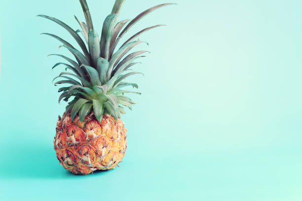 istock Ripe pineapple over blue background. Beach and tropical theme 1405575537