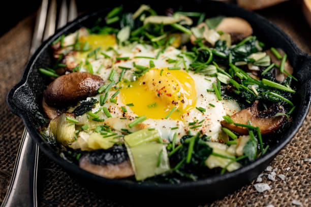 Baked Eggs With Spinach, Mushrooms and Leeks stock photo