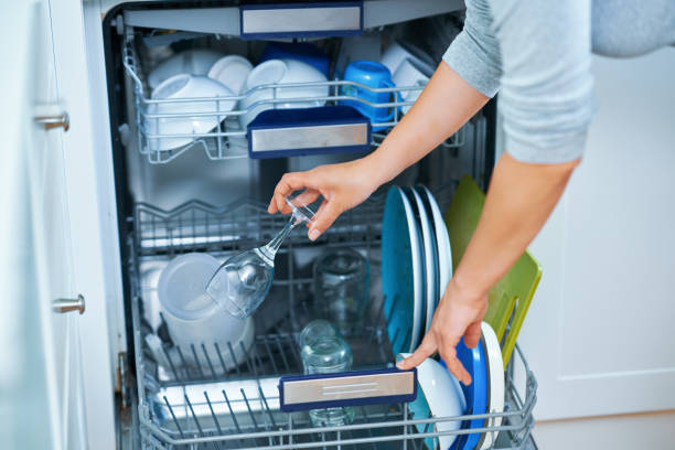 istock Young woman cleaning dishwasher in the kitchen 1405580001