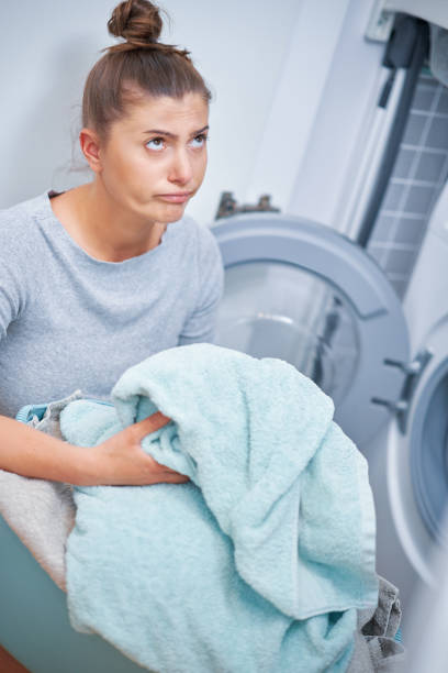 istock Picture of young woman making laundry work 1405580099