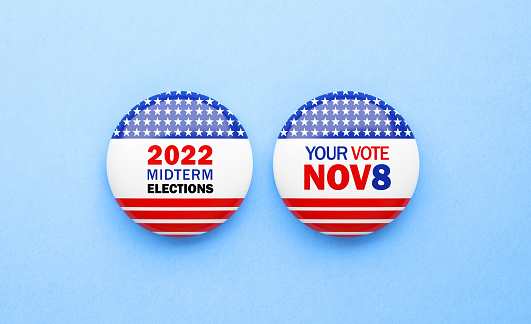 Your Vote Nov 8 and Midterm Election 2022 written badges sitting on blue background. Great use for election and voting concepts. 2022 US Midterm Election concept. Directly above.