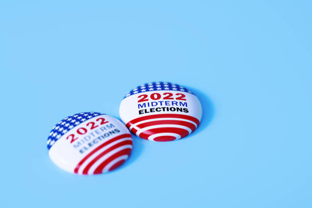 istock 2022 Midterm Elections Written Badge Pair Sitting on Blue Background 1405581957