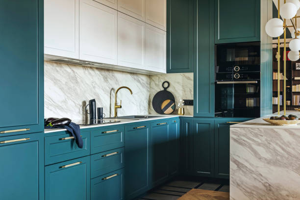 istock Luxury modern and vintage turquoise and white kitchen. Marble kitchen island with white owal chandelier . Gold tap on marble table top. Template. 1405582067