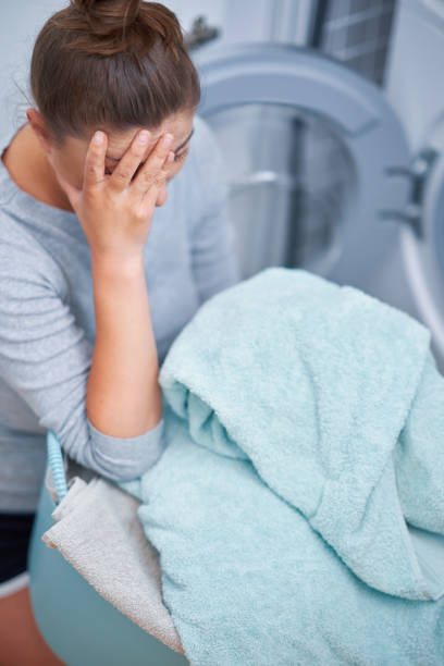 istock Picture of young woman making laundry work 1405582835