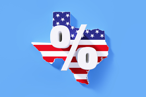 Percentage sign sitting over extruded physical map of Texas State textured with American flag on blue background. Horizontal composition with copy space.