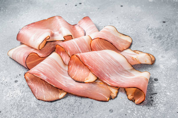 istock Black Forest Ham Slices on kitchen table. Gray background. Top view 1405585220