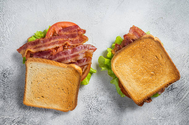 istock BLT toasted sandwich with bacon, tomato and lettuce. Gray background. Top view 1405585233