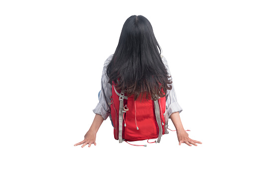 Rear view of Asian woman with backpack sitting isolated over white background