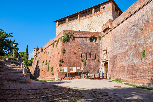 Tourists entering the Cassero Senese (English: Sienese Keep), a 14th-century fortification in Grosseto, incorporated in the city walls. It is currently used for artistic exhibitions.