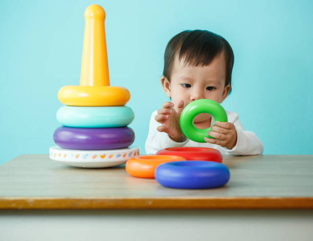 istock baby is playing with educational toys over blue background 1405588849